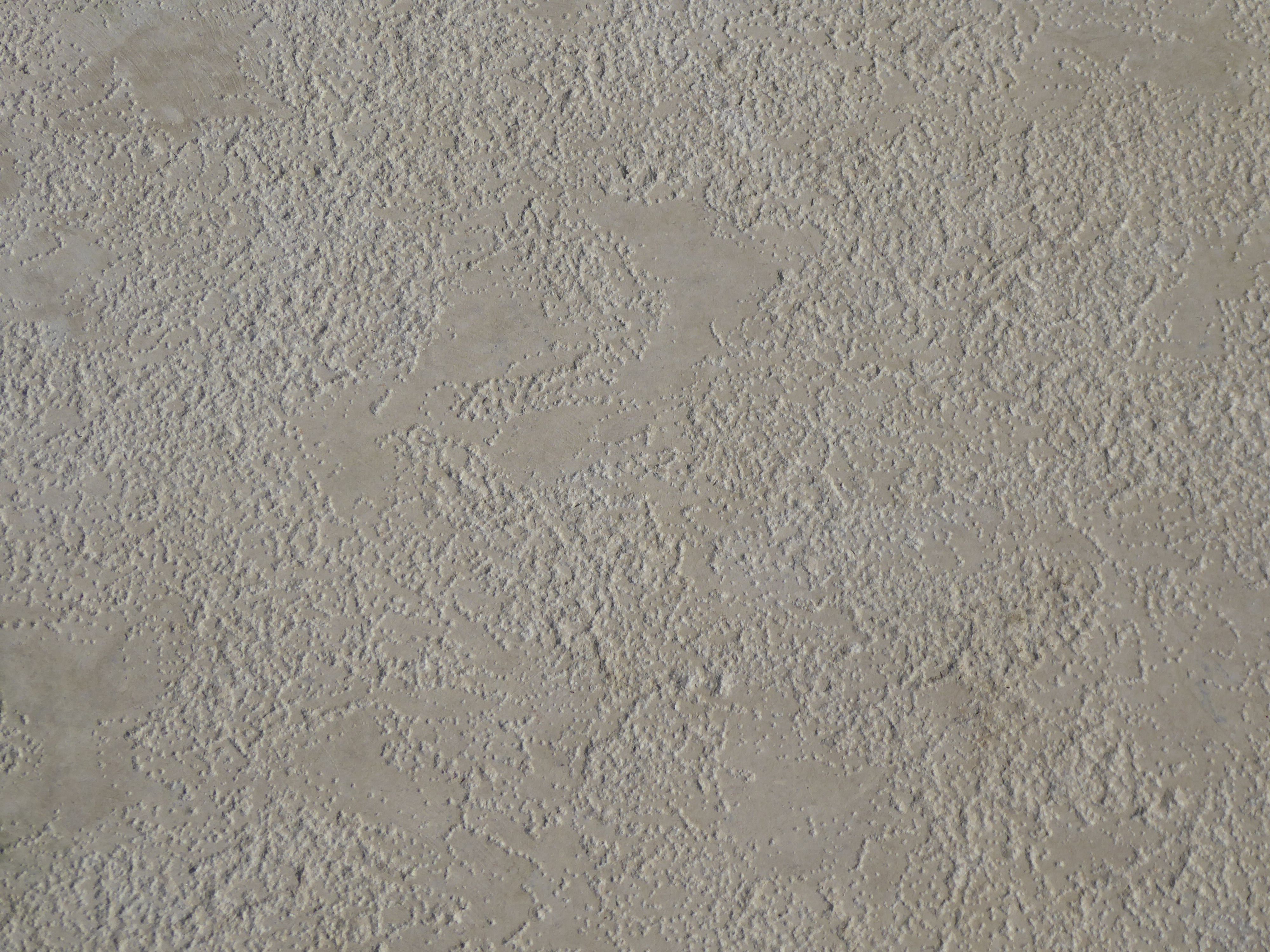 Close-up of a textured beige concrete surface, suitable for backgrounds or design projects.