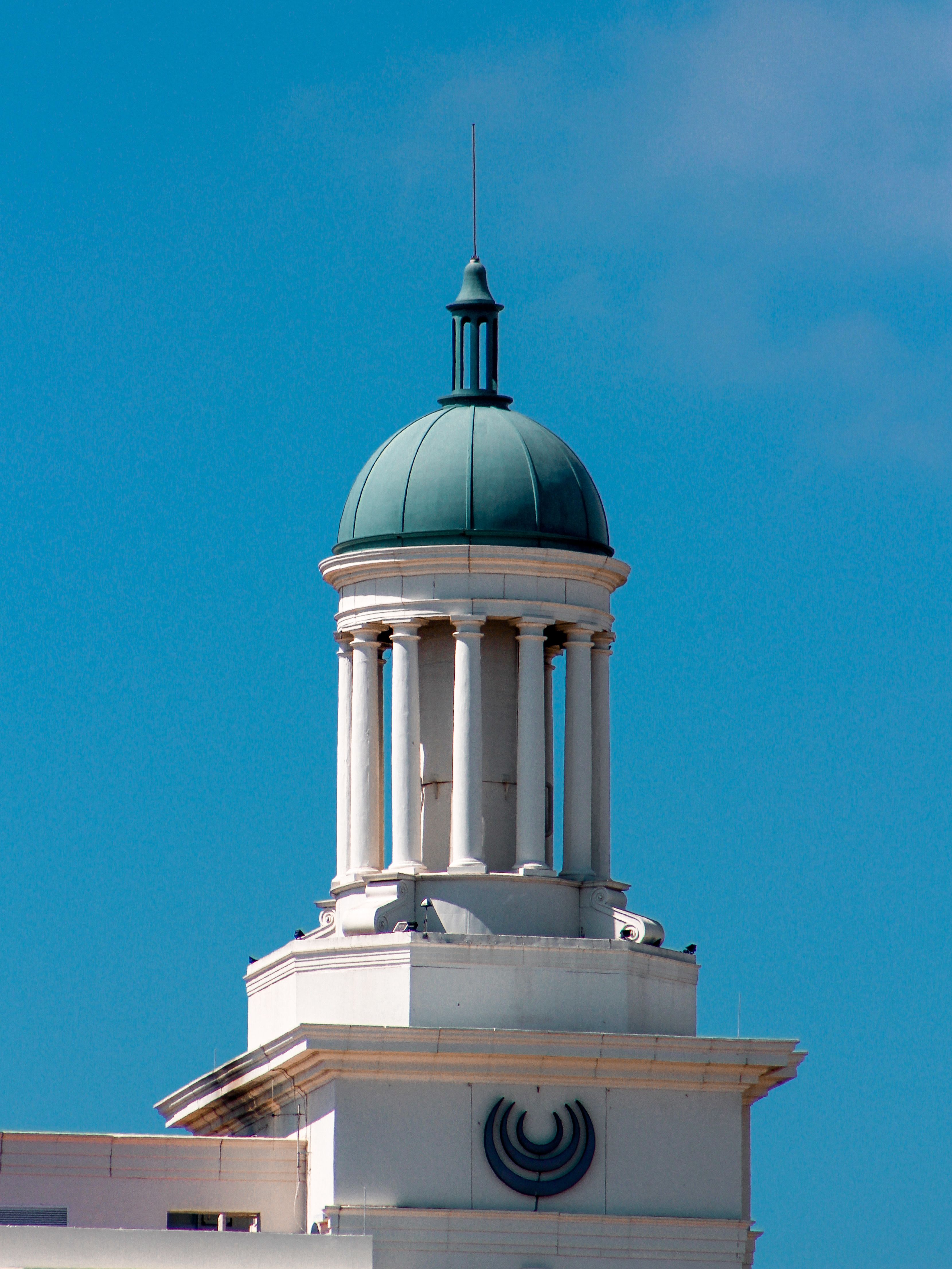 Close-up of a Tower with a Small Dome against a Blue Sky · Free Stock Photo