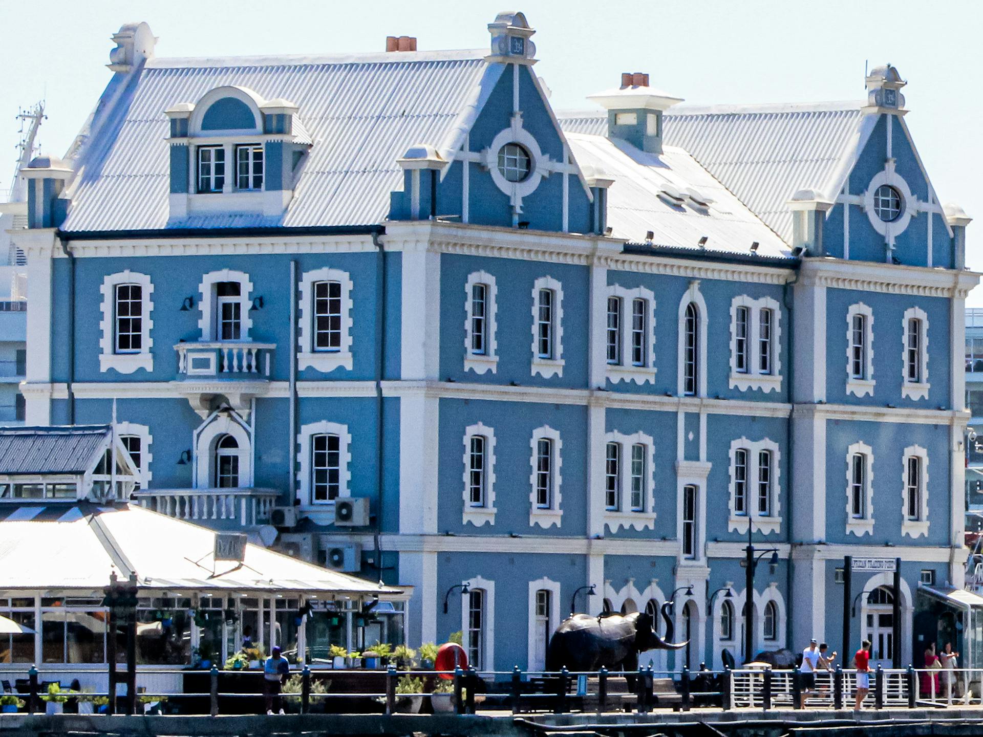 Charming blue and white historic building at Cape Town's vibrant waterfront.