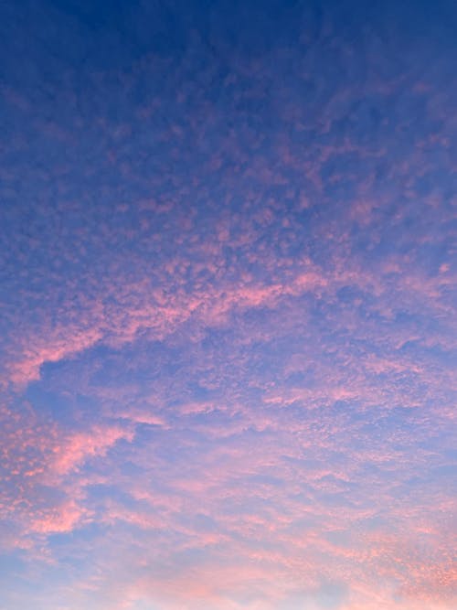 A pink sky with clouds in the background