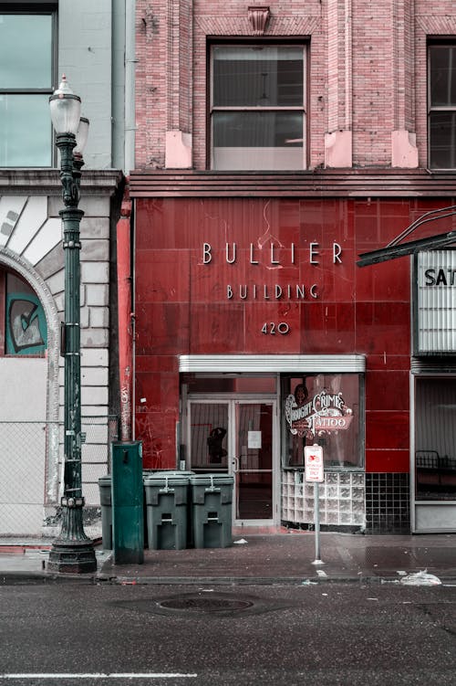 A black and white photo of a building with a red sign