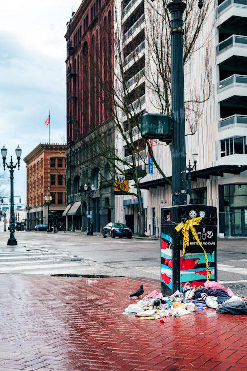 A street corner with trash and a sign on it