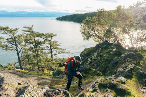 A hiker on a rocky trail near the ocean