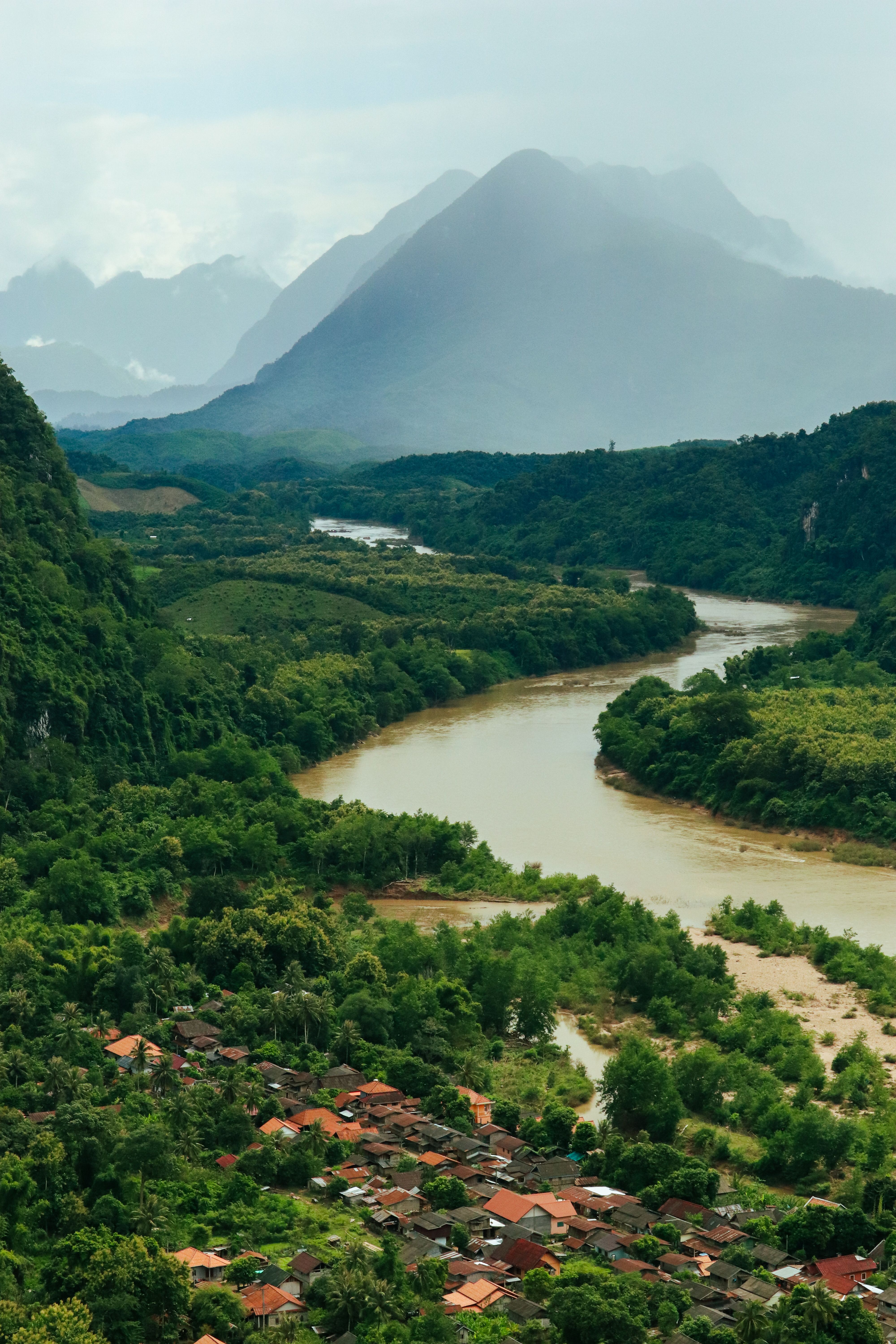 Aerial View of a River in a Green Valley and Mountains in Distance ...
