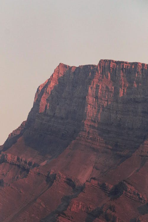 A red rock mountain with a red sky