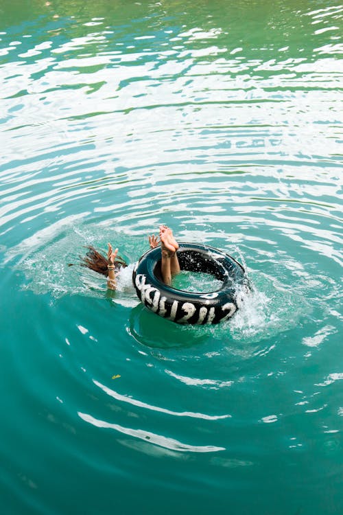 Girl under Swim Ring on Lake
