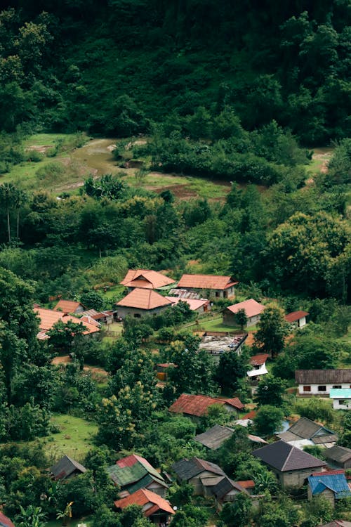 A village in the mountains with a green hillside