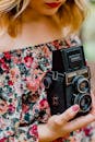 Woman Holding Black Nomo Vintage Camera