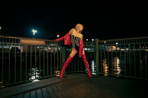 Young Asian Woman in Red Leather and Body Suit on Rainy Night San Francisco Pier