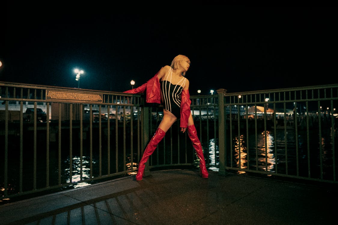 Young Asian Woman in Red Leather and Body Suit on Rainy Night San Francisco Pier