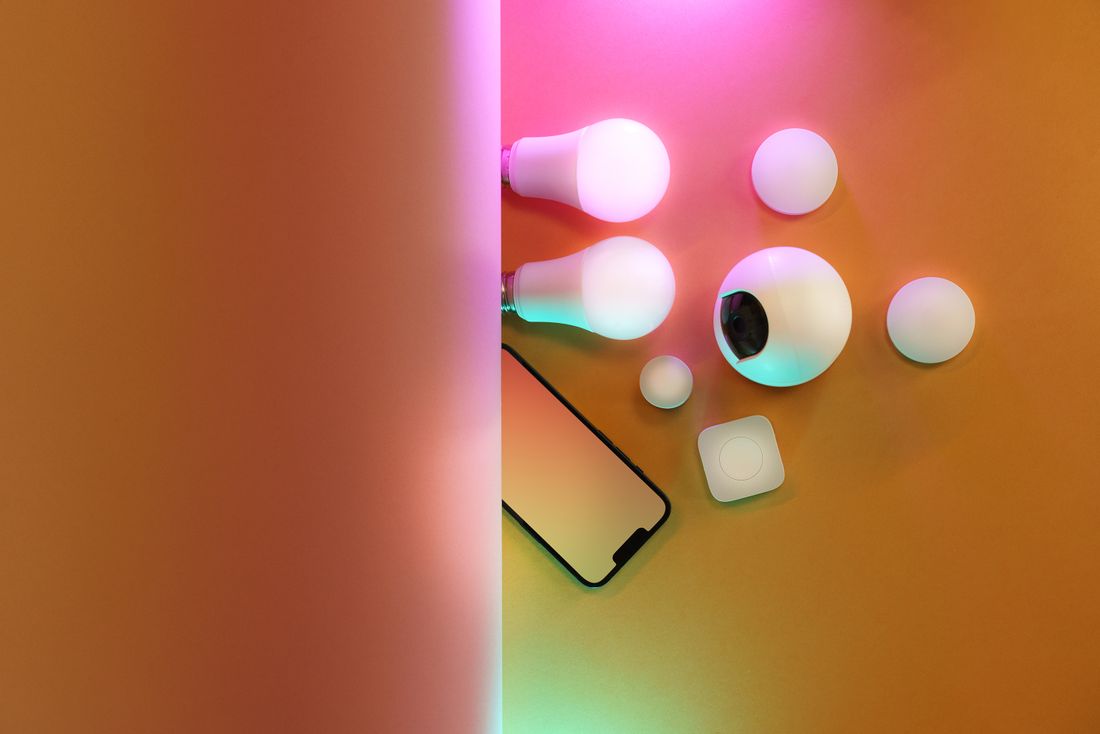 A flat lay of smart bulbs and devices