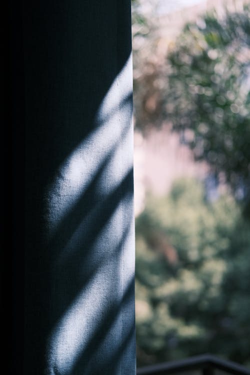 A shadow of a person standing in front of a window