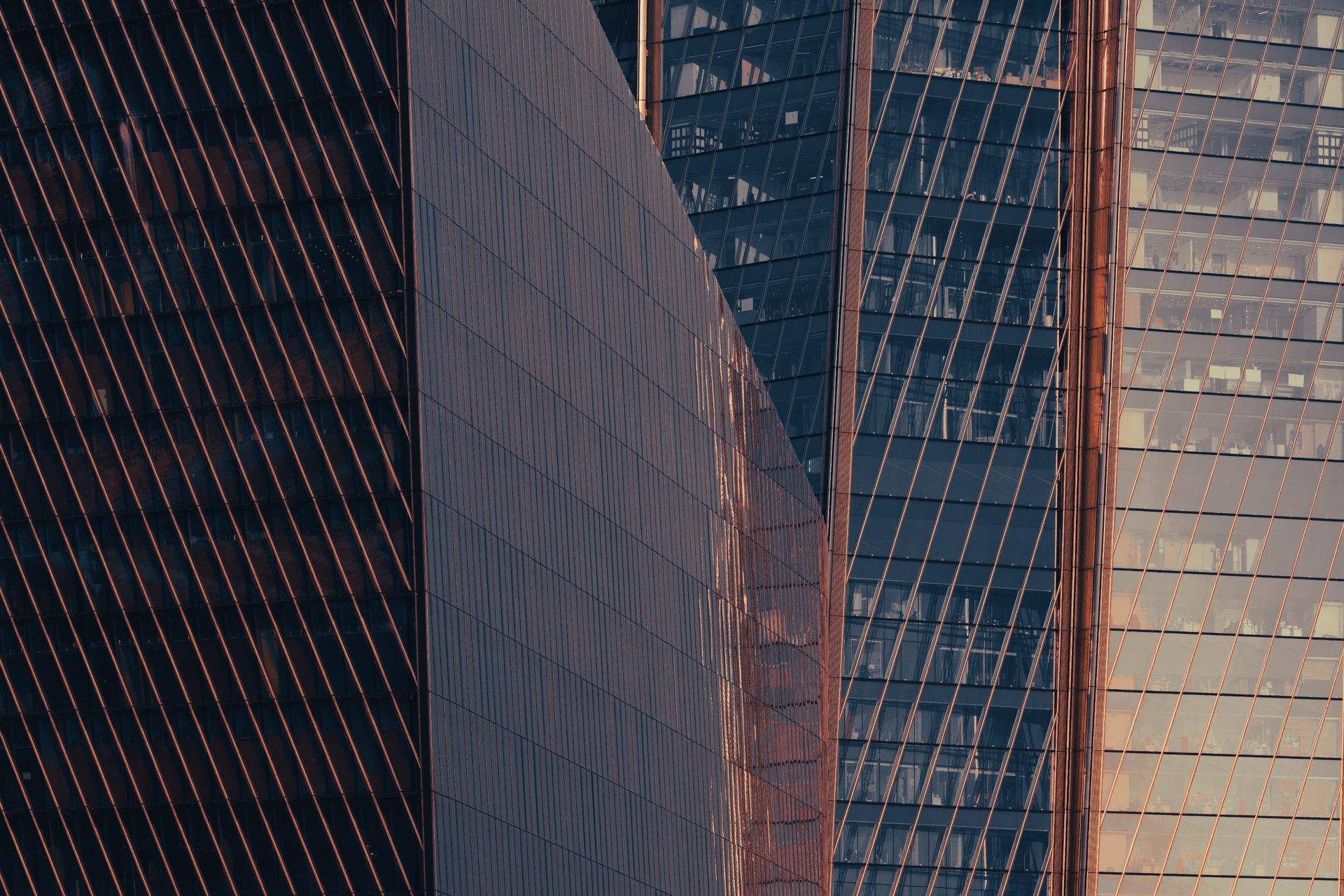 Captured at sunset, these modern skyscrapers with reflective glass in Saint Petersburg, Russia showcase architectural elegance.