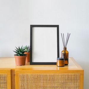 Framed print resting beside succulents, photo by Komet Flicker on Pexels