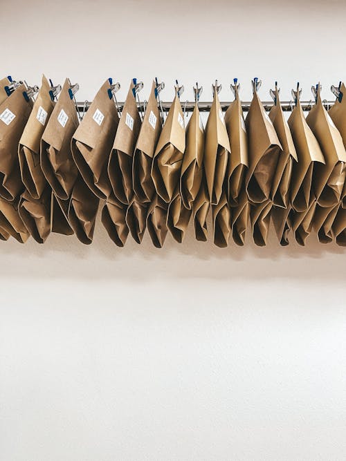 A rack of brown paper bags hanging on a wall