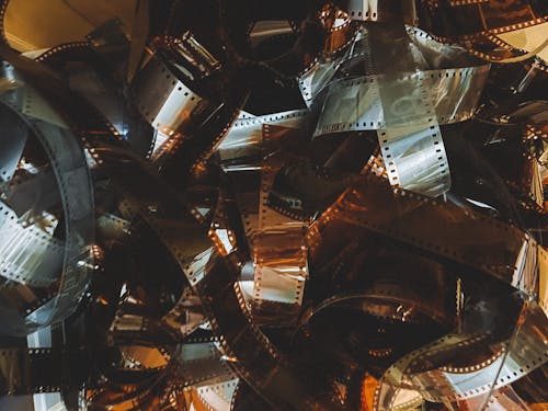 A pile of film reels with a black background