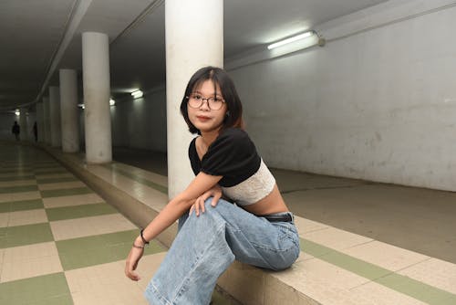 Woman Sitting on a Pavement