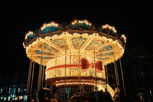 A carousel at night with lights on it