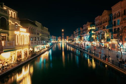 A canal in a city at night with lights