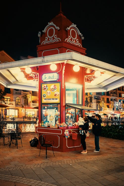 A red and white candy stand at night