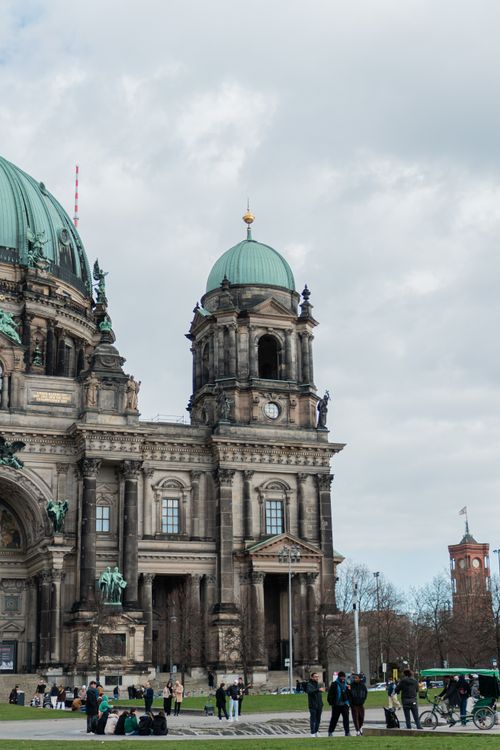 Free Historic Berlin Cathedral with visitors and cloudy skies, showcasing urban architecture. Stock Photo