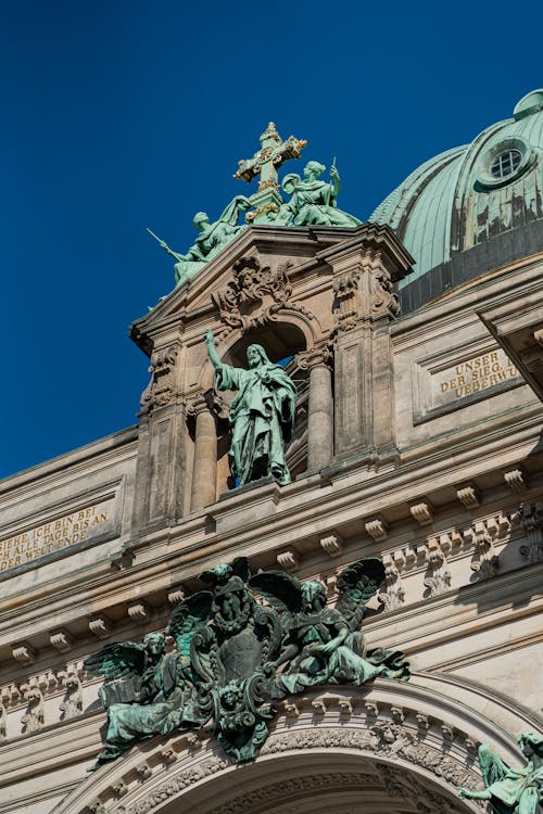 The ornate building has statues on top of it