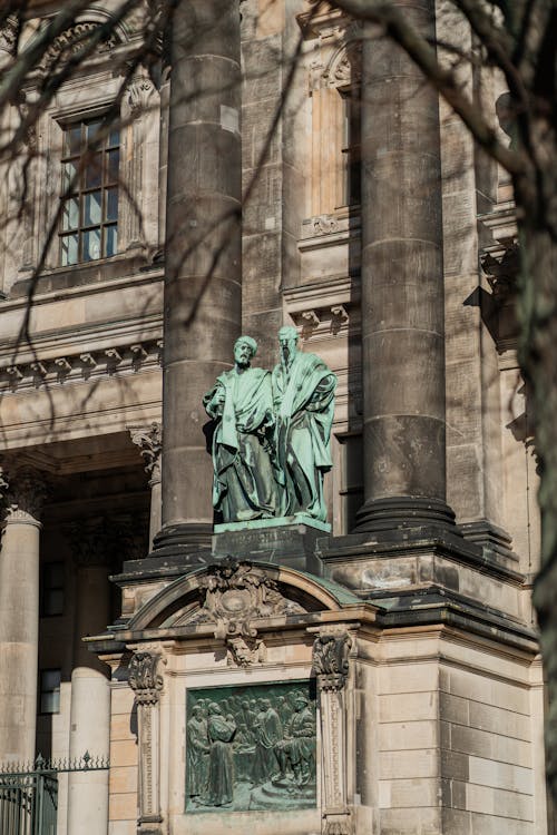 A statue of two men standing in front of a building