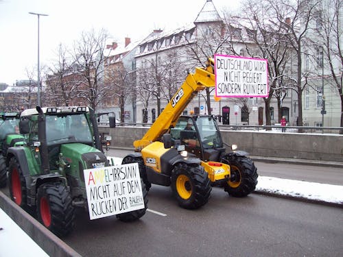 Tractors with Banners on Street in City in Winter