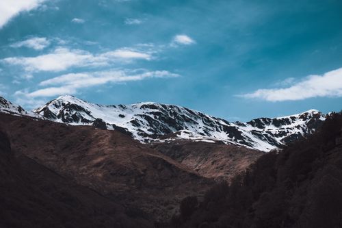 Free Breathtaking view of a snowcapped mountain range with clear blue skies, ideal for nature exploration. Stock Photo