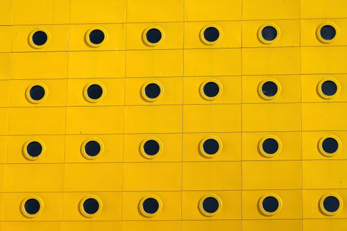 Free Abstract yellow facade with circular patterns in Jönköping, Sweden, showcasing modern Scandinavian design. Stock Photo