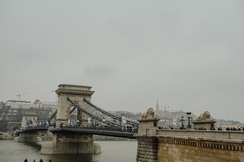 People walking on the bridge over the river