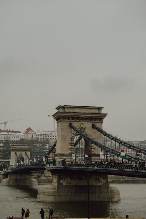 People walking on the bridge over the river