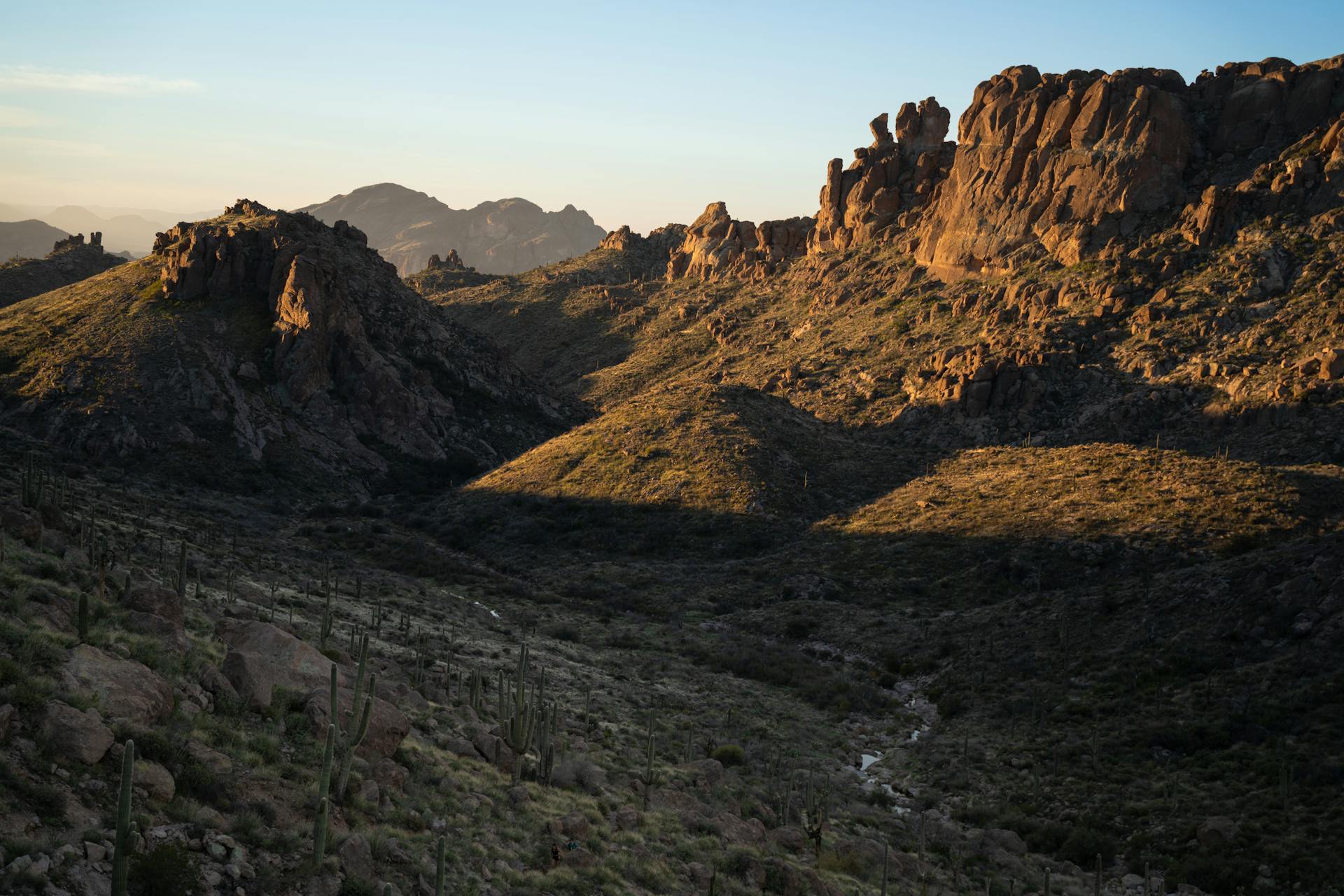 Breathtaking view of Superstition Mountains in Arizona during sunset, showcasing rugged peaks and desert landscape.