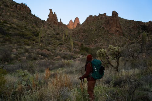 A person with a backpack hiking in the desert