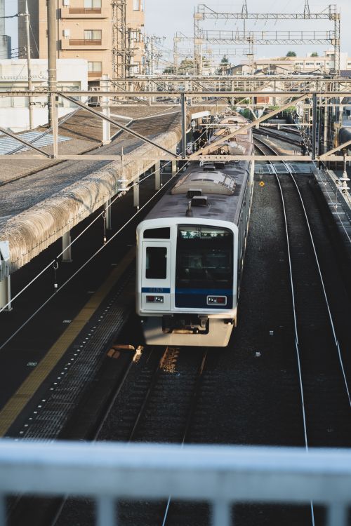 Free Train arriving at Saitama railway station showcasing urban transportation. Stock Photo