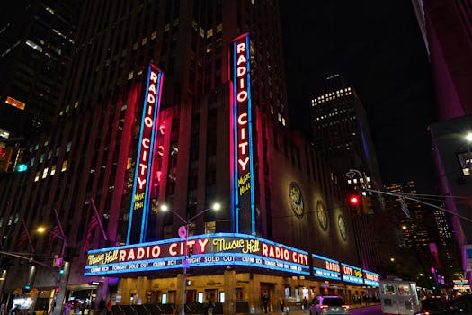 Vibrant neon lights of Radio City Music Hall illuminate New York City at night.