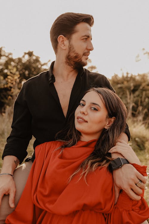 Portrait of Man in Black Shirt with Woman in Red Clothes