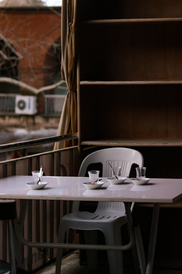 Empty Glasses And Plates On Table In Cafe