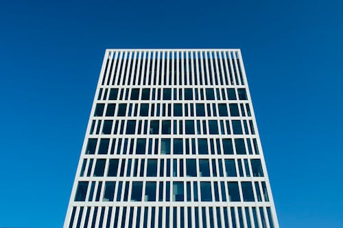 A tall building with windows against a blue sky