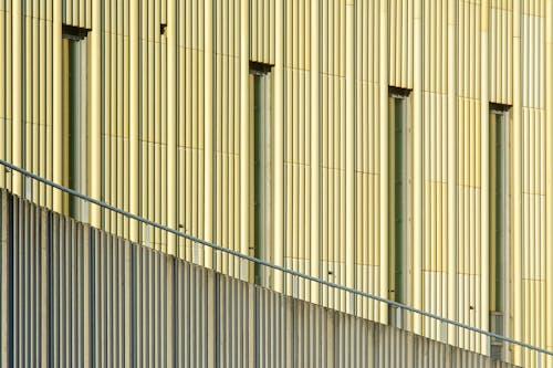 A yellow building with a metal railing