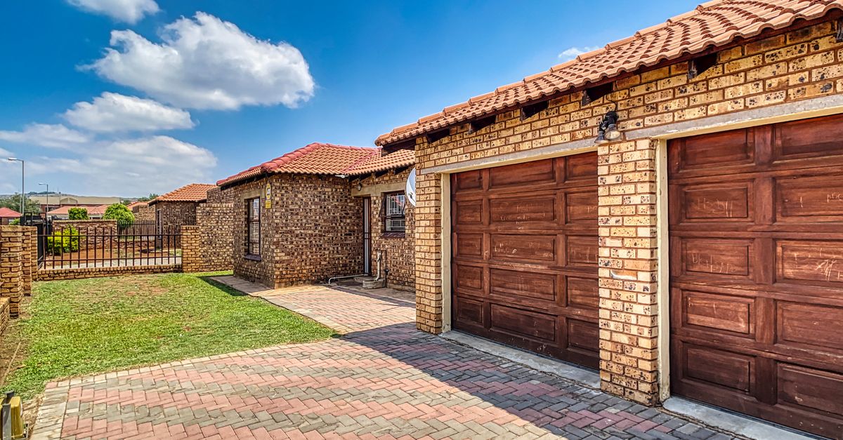 Beautiful brick home with double garage and paved driveway in Pretoria, South Africa.