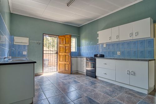 Free Spacious kitchen with blue tiles and natural light in a Pretoria home. Stock Photo