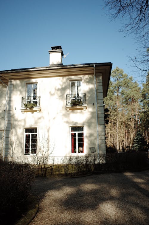 A large white house with windows and a chimney