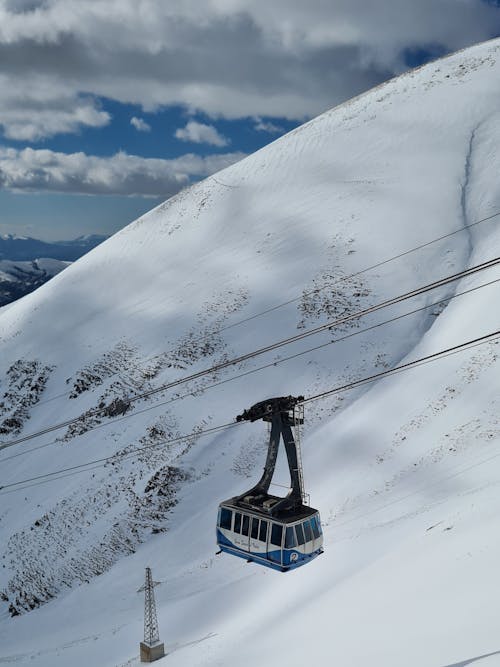 Cable Car over Snowed-covered Mountain Slope