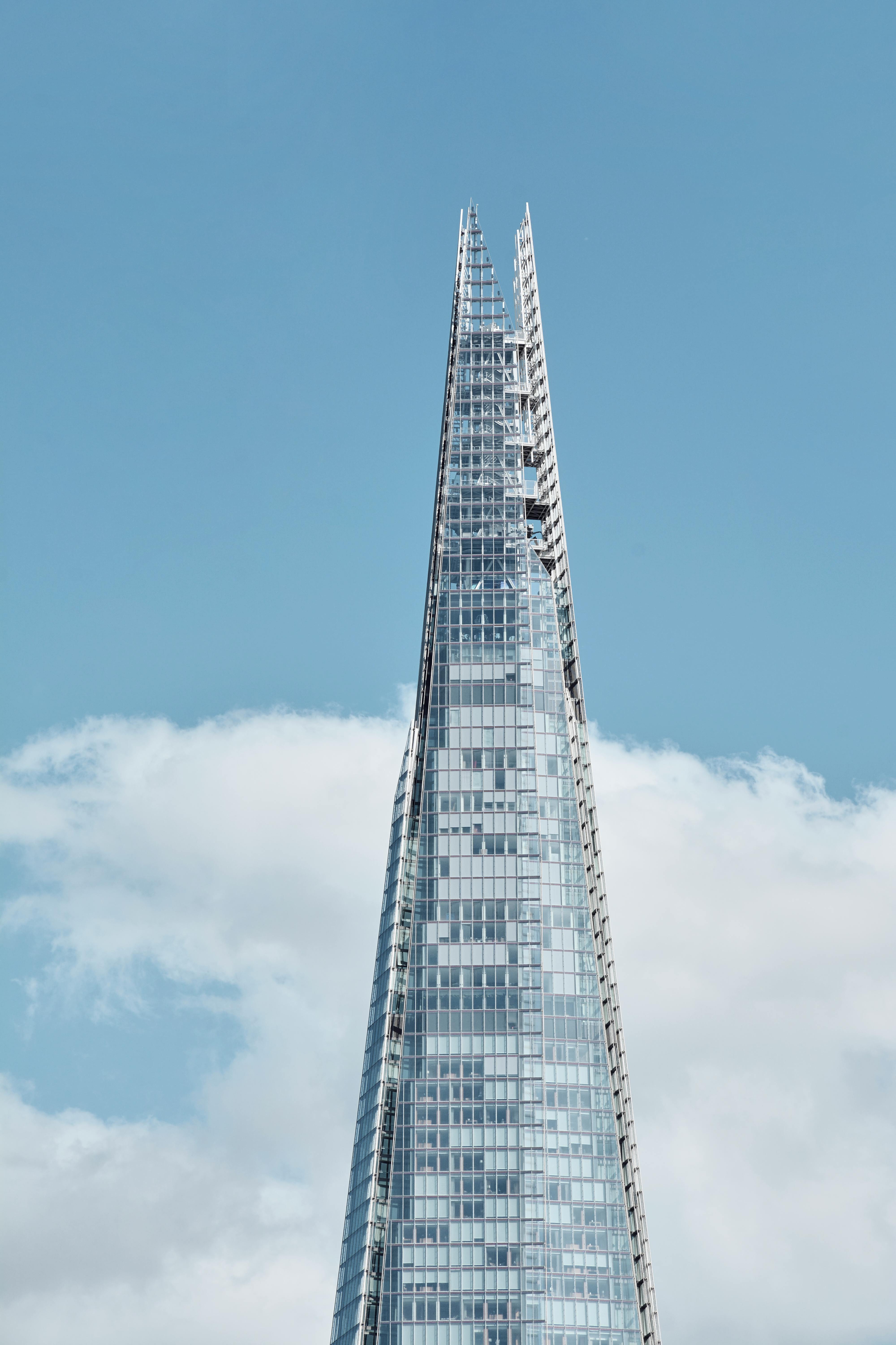 Modern architecture of the Shard skyscraper set against a clear blue sky in London.