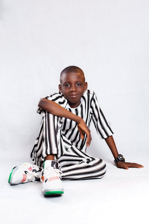Boy posing in striped clothes and Air Jordan Sneakers