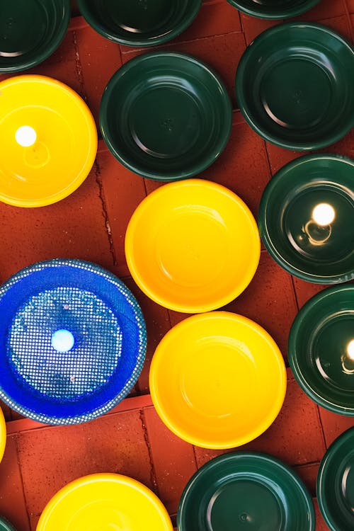 A bunch of colorful bowls and plates on a table
