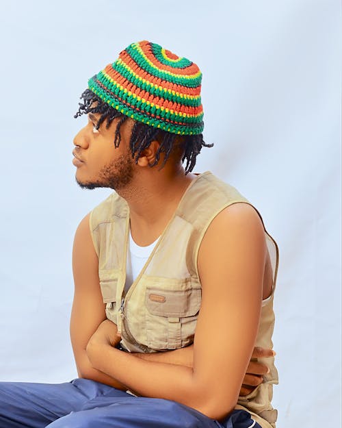 A young man wearing a colorful hat