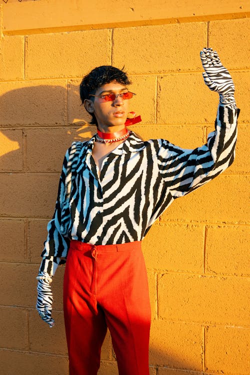 A man in a zebra print shirt and red pants