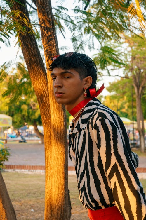 A young man in a zebra print shirt and red tie
